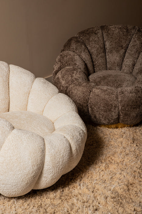 Twee bloemvormige fauteuils in crème en bruin polyester met goudkleurig onderstel op een hoogpolig tapijt.