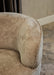 Beige fauteuil Filou van PTMD met gestructureerde polyester bekleding en een modern, rond ontwerp.