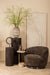 Bruine Filou fauteuil van PTMD met gestoffeerde polyester zitting en slank metalen onderstel in een warm interieur.