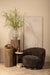 Bruine polyester fauteuil Filou van PTMD met een slank metalen onderstel in een sfeervol interieur.