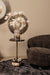Bruine fauteuil Filou van PTMD met polyester bekleding en slank metalen onderstel in een sfeervol interieur.