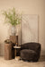 Bruine PTMD Filou fauteuil van polyester met een slank metalen onderstel in een sfeervol interieur.