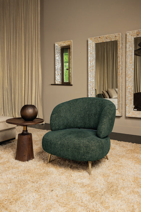 Olijfgroene fauteuil Franklyn van PTMD met polyester bekleding en slank metalen onderstel in een modern interieur.