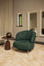 Olijfgroene fauteuil Franklyn van PTMD met polyester bekleding en slank metalen onderstel in een modern interieur.