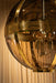 Grote ronde PTMD hanglamp van goudkleurig messing en glas, 66x66x91 cm, met een luxe, tijdloze uitstraling.