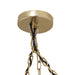 Gouden plafondkap van de PTMD Wilco hanglamp met bijpassende metalen kettingen en zwarte stroomkabels.