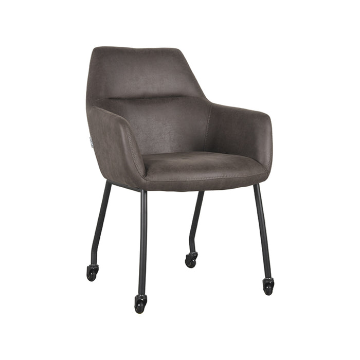 LABEL51 Lenny eetkamerstoel in antraciet micro-suède met armleuningen en zwart metalen frame op wieltjes.