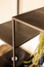 Zwarte PTMD vakkenkast van ijzer met houten planken, 40x110 cm, in een modern en strak industrieel design.
