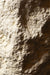 Close-up van de witte, ruwe betonstructuur van de PTMD Haride salontafel.