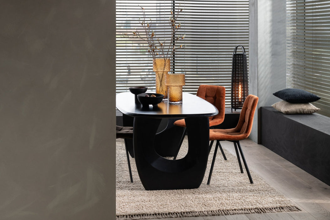 Zwarte vloerlamp van 100 cm hoog in een modern interieur met textiel en bamboe accenten naast een eettafel.