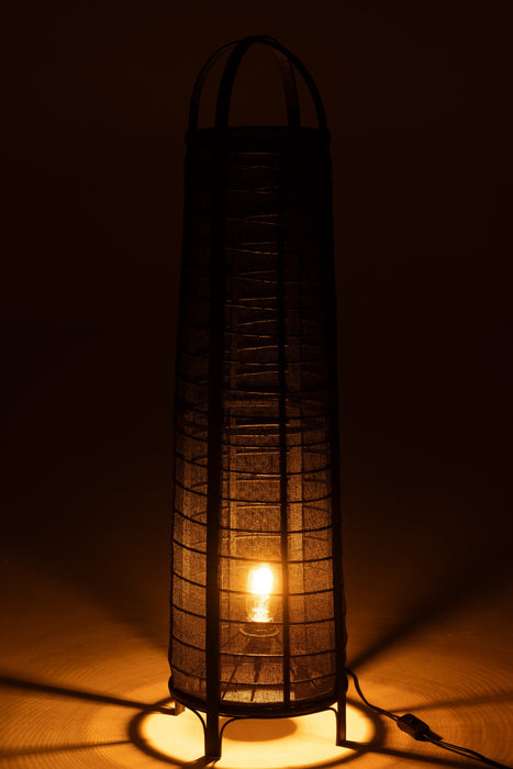 Zwarte, cilindervormige vloerlamp van 100 cm hoog met een textielstructuur en sfeervolle warme verlichting.