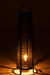 Zwarte, cilindervormige vloerlamp van 100 cm hoog met een textielstructuur en sfeervolle warme verlichting.